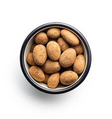 Almonds in chocolate coated in cocoa powder isolated in bowl on white background.