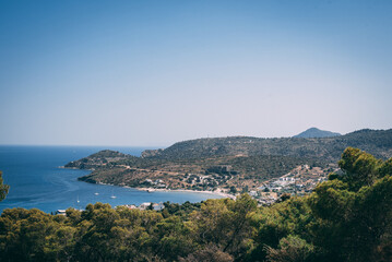 Fototapeta na wymiar Coastal hills frame a serene Mediterranean bay, where the sea stretches out invitingly.