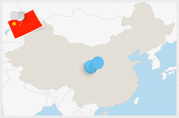 Map of China with a pinned blue pin. Pinned flag of China.