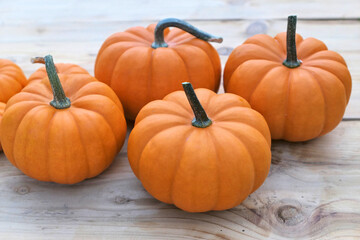 Orange pumpkins on wooden background.