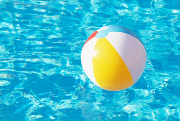 Colorful inflatable ball floating in swimming pool