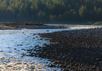 People along river fishing in October