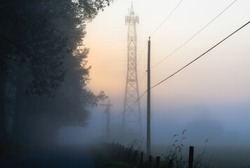 Power tower in early morning fog