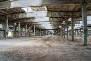 Fototapeta na wymiar Ruined industrial area, abandoned ruins of a plant or factory. Huge vacant lot. Background