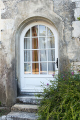 Traditional entrance with a wooden and glass door.