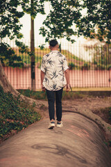 Fototapeta premium Young brunette boy in natural park