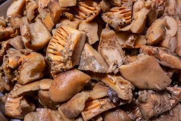 Tasty edible mushroom Lactarius deliciosus sliced for loading and preparing soup