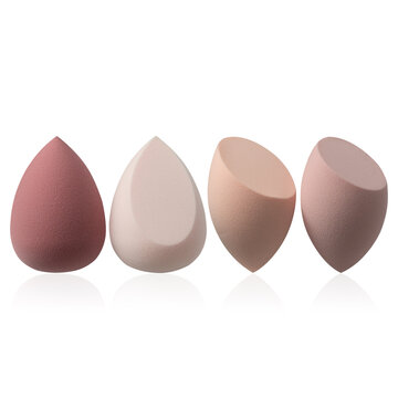 Set of four beauty blenders on a white background