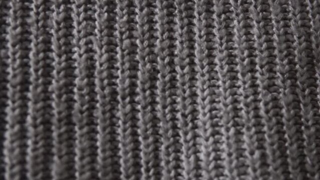 Knitted gray acrylic fabric panoramic detailed view. Sweater, warm plaid, scarf. 