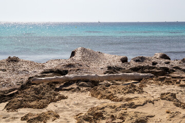 Rocky beach with a turquoise blue sea and waves in spain