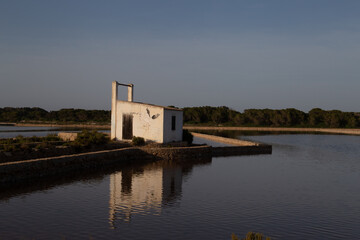Fototapeta na wymiar Small cabin near a lagoon where sea salt is produced