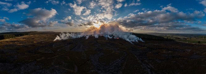 Fototapeta premium Heather burning on moorland above Holmfirth in West Yorkshire, long history of use in managing moorland. 