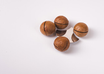 Composition with organic Macadamia nuts on white background, top view