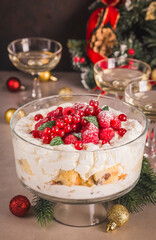 Christmas trifle with panettone and cream with berries on festive table