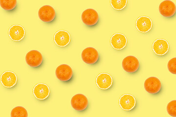 Oranges and slices of oranges isolated on yellow background