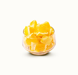 Glass bowl with chopped oranges on a white background