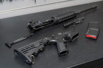 An ar 15 or m4a1 cleaning and repair rifle disassembled in a weapons workshop.