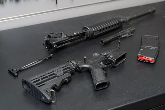 An ar 15 or m4a1 cleaning and repair rifle disassembled in a weapons workshop.