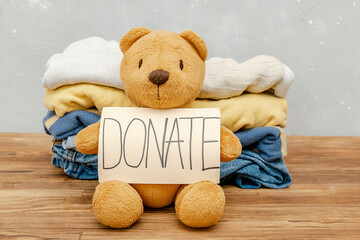 Stack of baby children clothes,teddy bear toys.Donation,volunteering help,humanitarian aid.charity