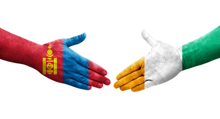 Handshake between Ivory Coast and Mongolia flags painted on hands, isolated transparent image.