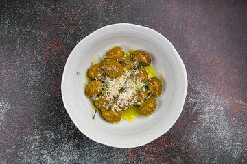 green olives in a bowl on a dark background in a restaurant