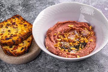 hummus in a plate and bread with raisins in a restaurant