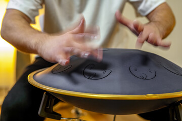 hands playing on the black Sonodrum