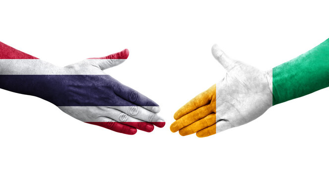 Handshake between Ivory Coast and Thailand flags painted on hands, isolated transparent image.
