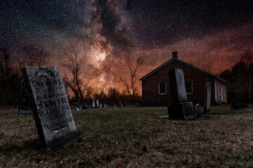 An old church and its graveyard, seen here under a starry night sky, are all that remains of the...