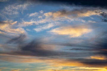 Naklejka na ściany i meble Sunrise dramatic sky with clouds in a row, colorful cloudscape