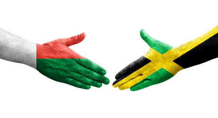 Handshake between Jamaica and Madagascar flags painted on hands, isolated transparent image.