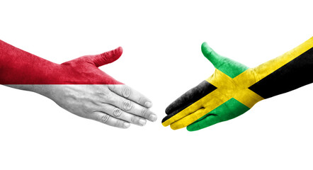 Handshake between Jamaica and Monaco flags painted on hands, isolated transparent image.
