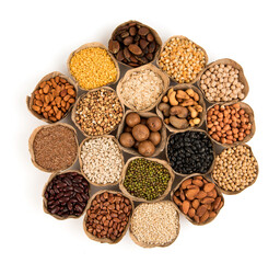 Many cereals such as walnuts, macadamia, green peas, almonds and others isolated on white background.