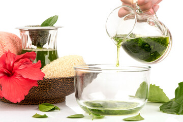 Hair care with red hibiscus flowers and green leaves isolated on white background. © wasanajai