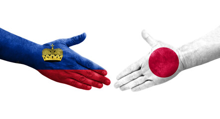 Handshake between Japan and Liechtenstein flags painted on hands, isolated transparent image.