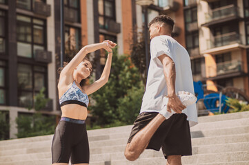 Young people having workout together and looking involved