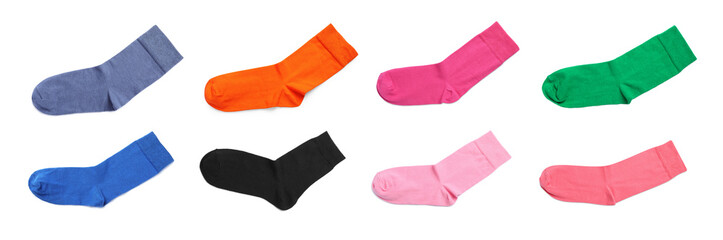 Set with pairs of different color socks on white background, top view. Banner design