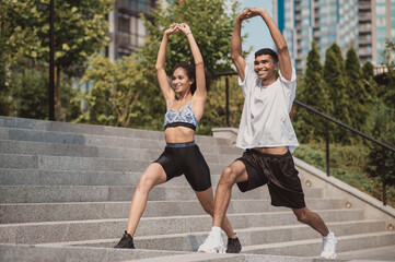 A girl and a guy having a workout outside