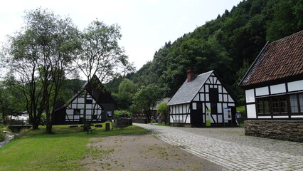 Fototapeta na wymiar River, grass, road, old german village, trees, mountain at hagen, germany