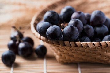 Black grape in bamboo basket, Healthy fruit