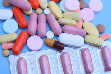 capsules pill on blue background. Antibiotics drug resistance. Antimicrobial capsule pills. Pharmaceutical industry. With space for text or image. great for background. 