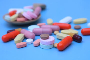 capsules pill on blue background. Antibiotics drug resistance. Antimicrobial capsule pills. Pharmaceutical industry. With space for text or image. great for background. 