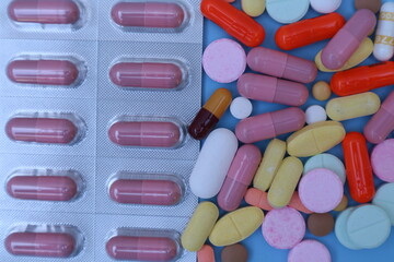 capsules pill on blue background. Antibiotics drug resistance. Antimicrobial capsule pills. Pharmaceutical industry. With space for text or image. great for background. 