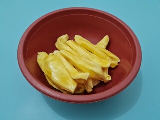 Slices of ripe yellow jackfruit in a container