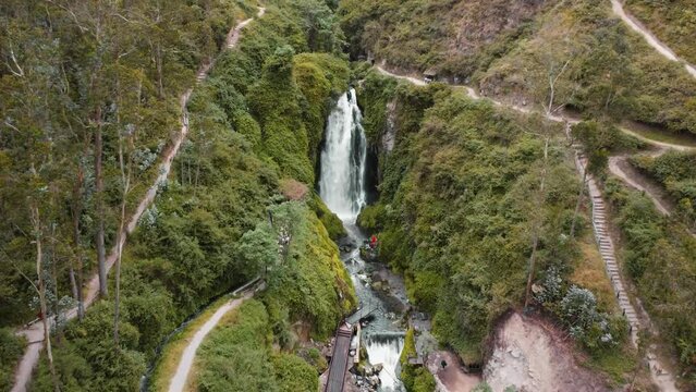 Aerial View Of Peguche Waterfall In Otavalo With Ascending Dolly Back Reveal
