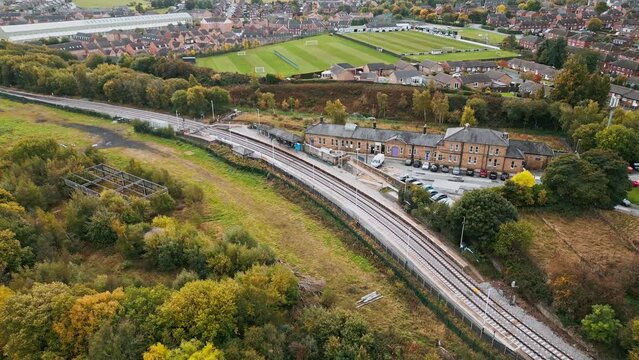 Drone footage of the Penistone Railway Station and Viaduct near Barnsley, South Yorkshire. Showing a ploughed field, bridge, woodland and railway tracks.