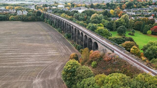 Drone footage of the famous Penistone Railway Station and Viaduct near Barnsley, South Yorkshire. Showing a ploughed field, bridge, woodland and railway tracks.