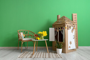 Interior of children's room with cardboard toy house