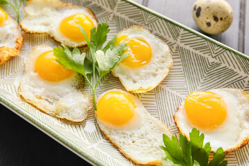 Plate with tasty fried quail eggs, closeup