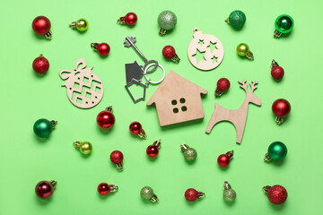 House figure with key and Christmas decor on green background